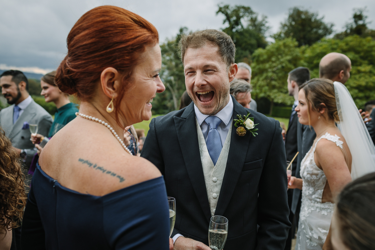 cowdray_house outside terrace wedding reception bride groom wedding photo authentic natural unposed wedding photography west_sussex award_winning photographer