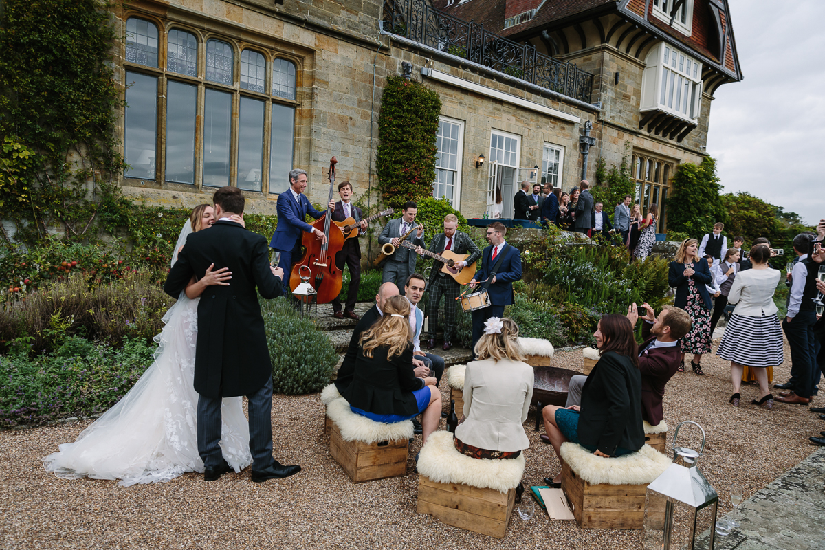 cowdray_house outside terrace wedding reception The_London_Essentials performance performing bride groom country house venue west_sussex award_winning photographer