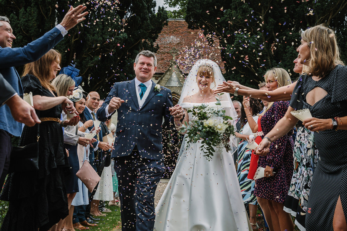 brockham church wedding ceremony bride groom confetti exit surrey for natural and authentic wedding portraits by documentary wedding photographer surrey and sussex