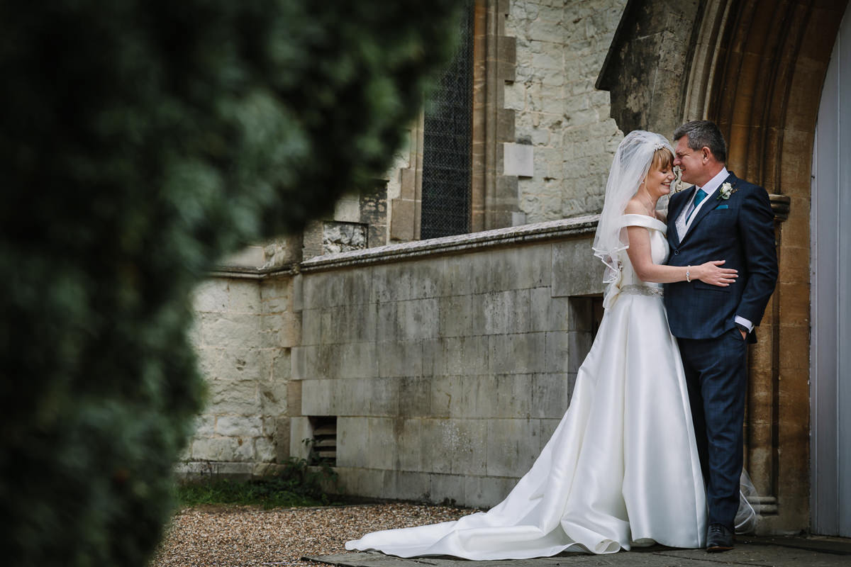 couple portrait at brockham christ church wedding ceremony bride groom surrey natural and authentic wedding portraits by documentary wedding photographer surrey and sussex