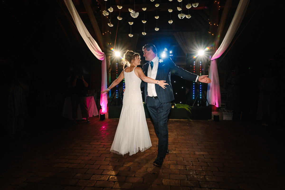 bride groom first dance at barn wedding venue gildings farm newdigate surrey for natural authentic wedding portraits by documentary wedding photographe