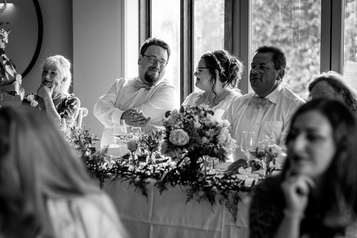 bride and groom wedding breakfast speeches at venue hampton_court_palace_golf_club natural light authentic documentary real_moments black_white photography