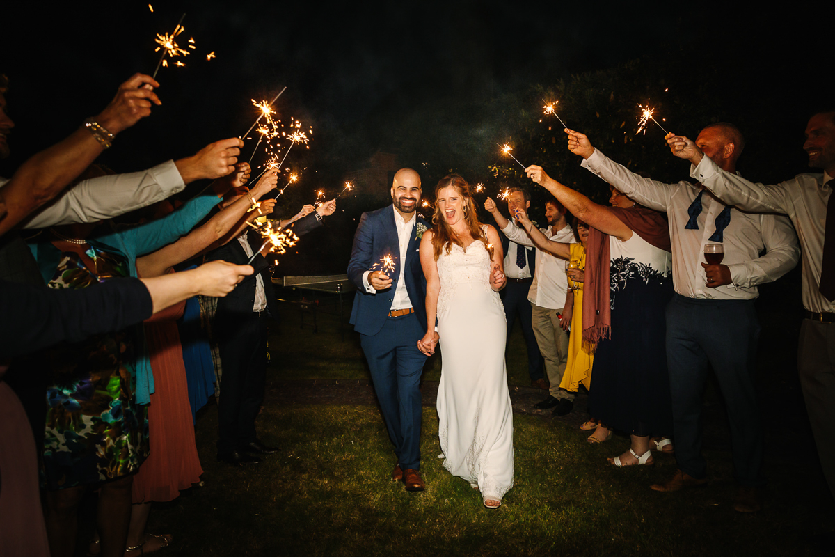 bride groom sparkler exit outdoor wedding natural authentic wedding portraits by documentary wedding photographer