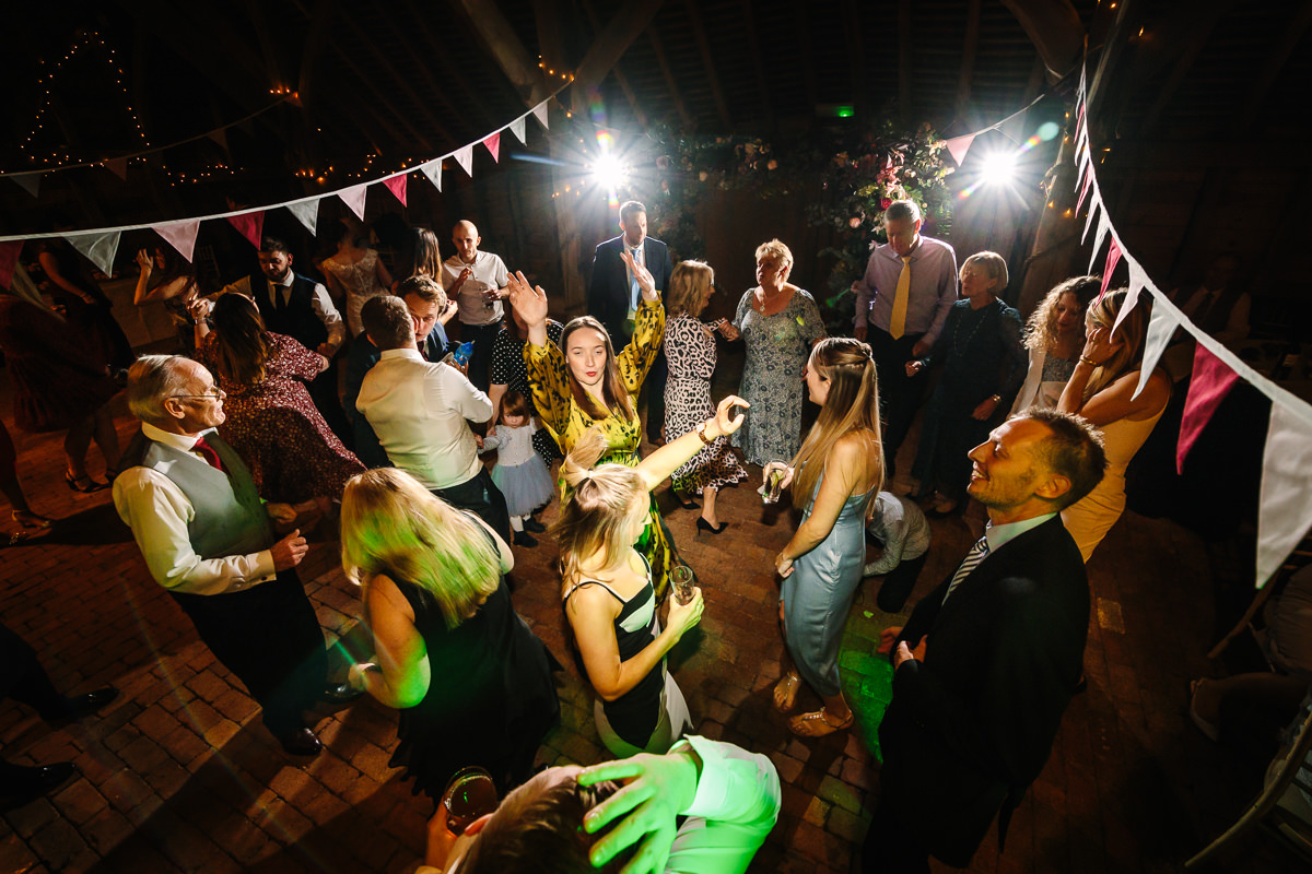 wedding party at gildings barns newdigate guests dancing having fun natural authentic colourful wedding photography documentary wedding photographer guildford surrey and horsham west_sussex