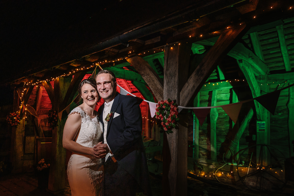  bride and groom wedding portrait gildings barns newdigate evening dark off_camera_flash coloured gels red green christmas atmosphere surrey barn wedding venue authentic wedding photography by documentary wedding photographer guildford surrey and horsham west_sussex