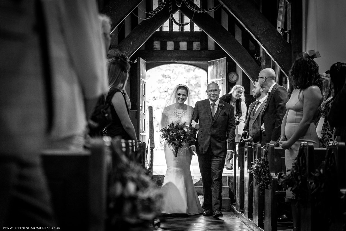 bride and father_of_the_bride st_peter church newdigate religious wedding ceremony bride groom black_white photo natural and authentic wedding portraits by documentary wedding photographer surrey and sussex