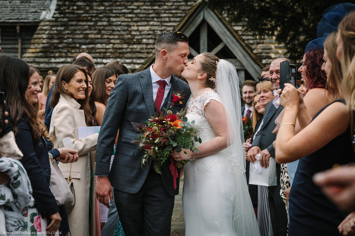 bride and groom confetti exit at st_peter church newdigate religious wedding ceremony bride groom photo natural and authentic wedding portraits by documentary wedding photographer surrey and sussex