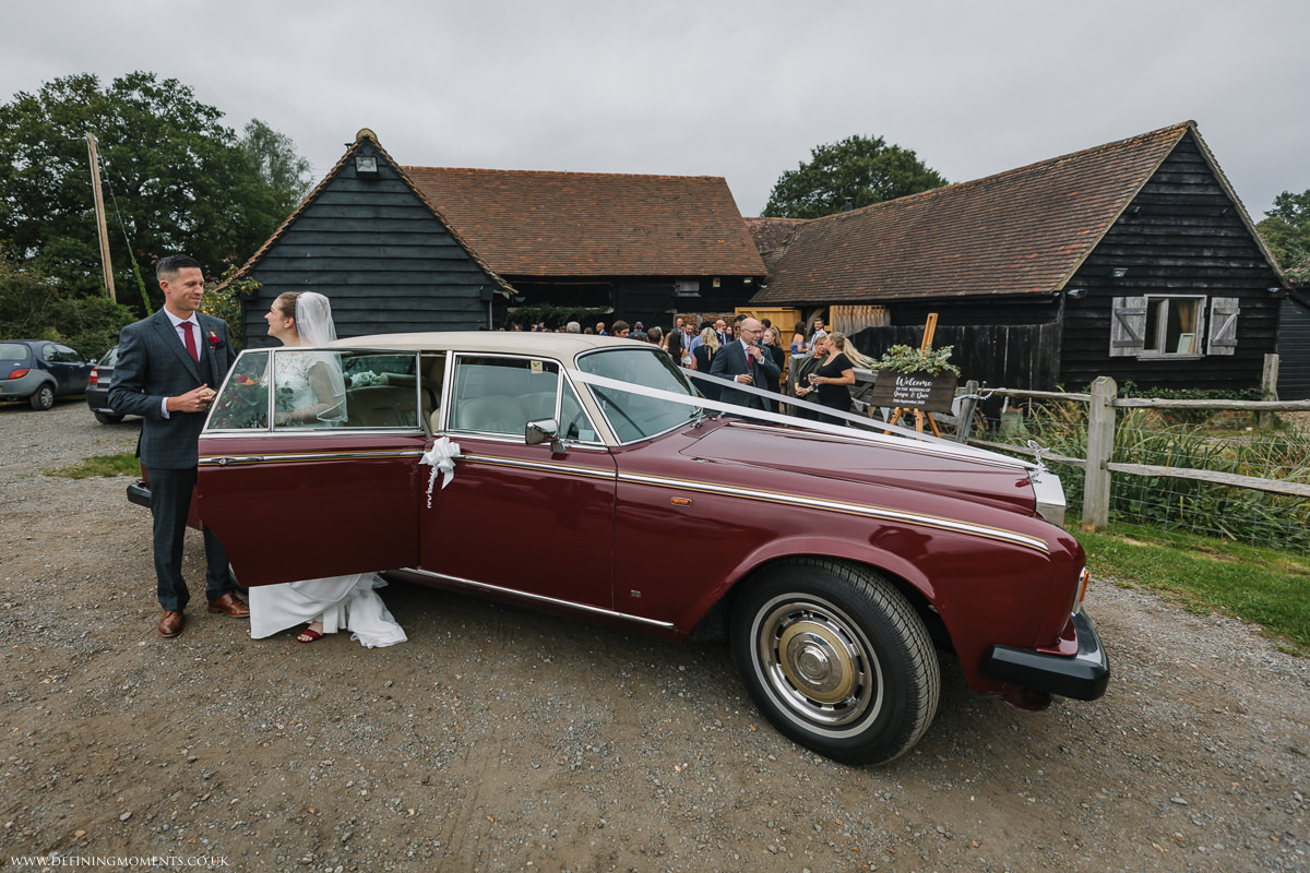 bride groom arrival at gildings barns newdigate surrey barn wedding reception venue bride groom photo natural and authentic wedding portraits by documentary wedding photographer sussex
