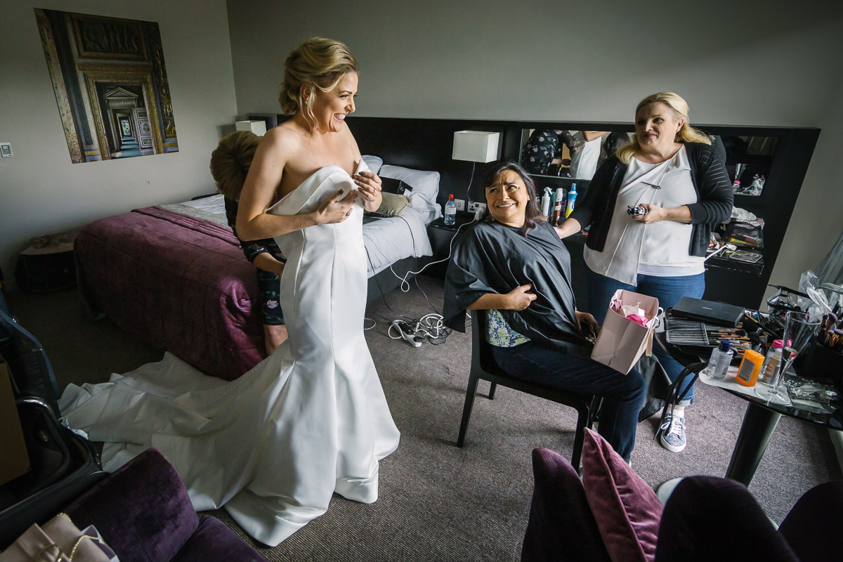 getting ready wedding dress fitting by lgbtq_friendly documentary wedding photographer surrey for natural candid colourful authentic unposed wedding photography