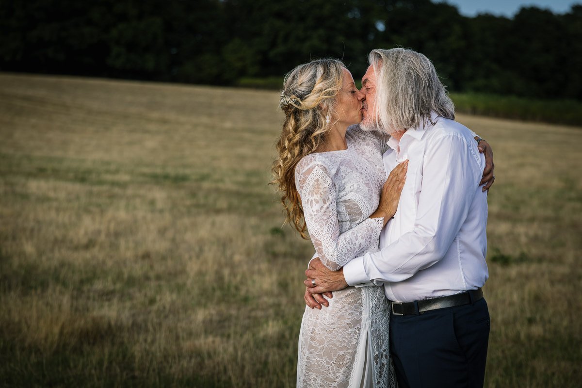 bride and groom portrait kissing at outdoor tipi wedding dorking surrey by documentary wedding photographer sussex for candid natural unposed authentic LGBTQ_friendly documentary photography