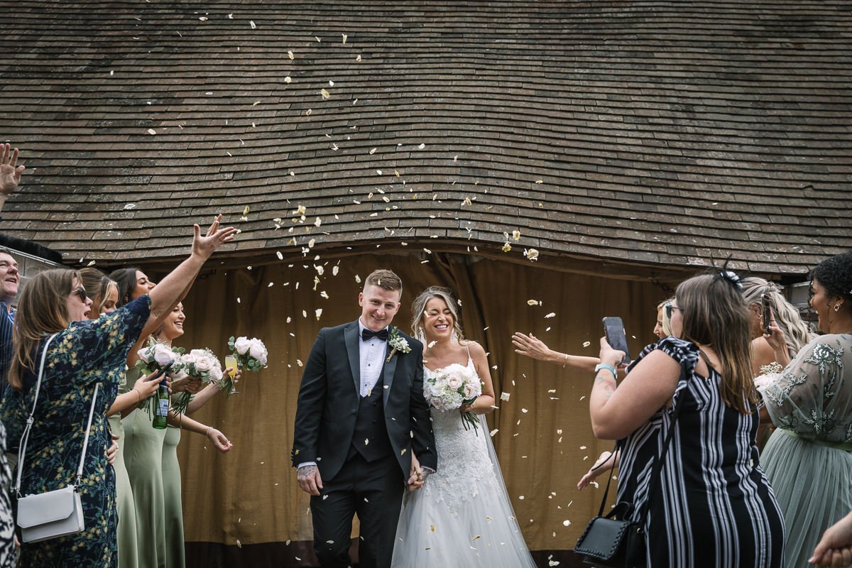 confetti moments after outdoor wedding ceremony gildings barns surrey unposed natural candid documentary photography sussex
