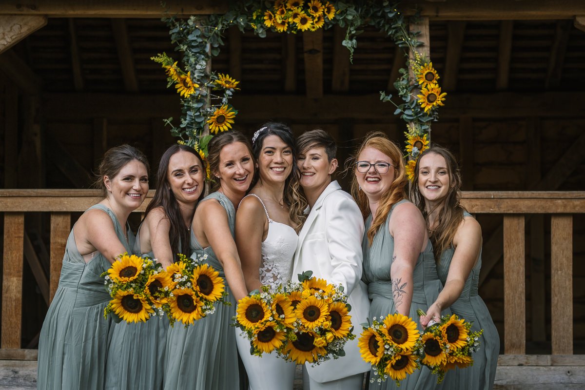 brides and bridesmaids at same_sex gay wedding at gildings_barns with natural unposed candid photography by LGBTQ friendly wedding photographer surrey sussex
