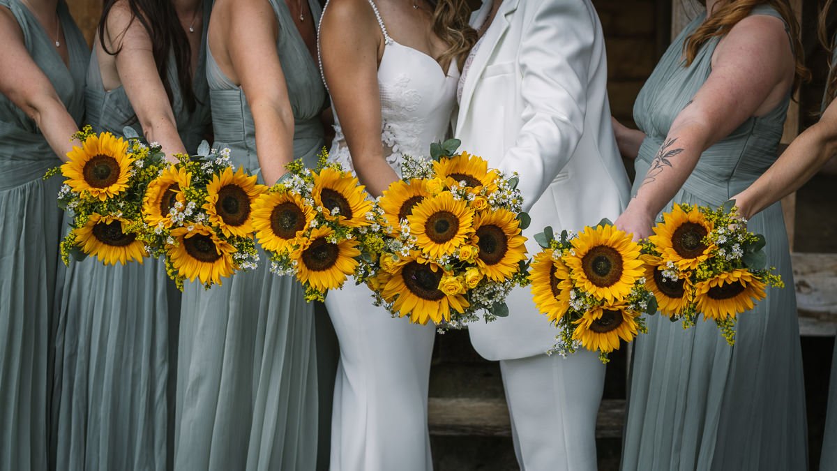 wedding bouquet sunflowers close-up image at same_sex gay wedding at gildings_barns with natural unposed candid photography by LGBTQ friendly wedding photographer surrey sussex