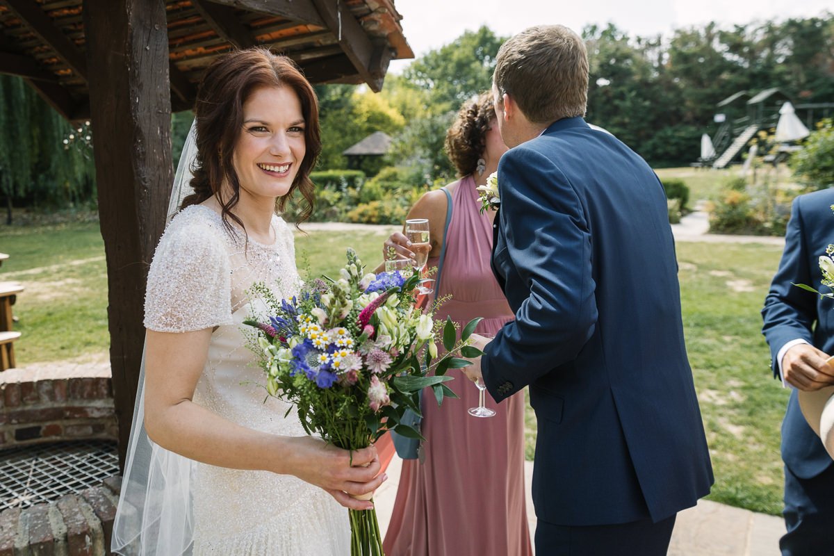 smiling bride after ceremony barn wedding venue kent the_plough_at_leigh bride and groom natural authentic colourful wedding photography documentary wedding photographer guildford surrey and horsham west_sussex
