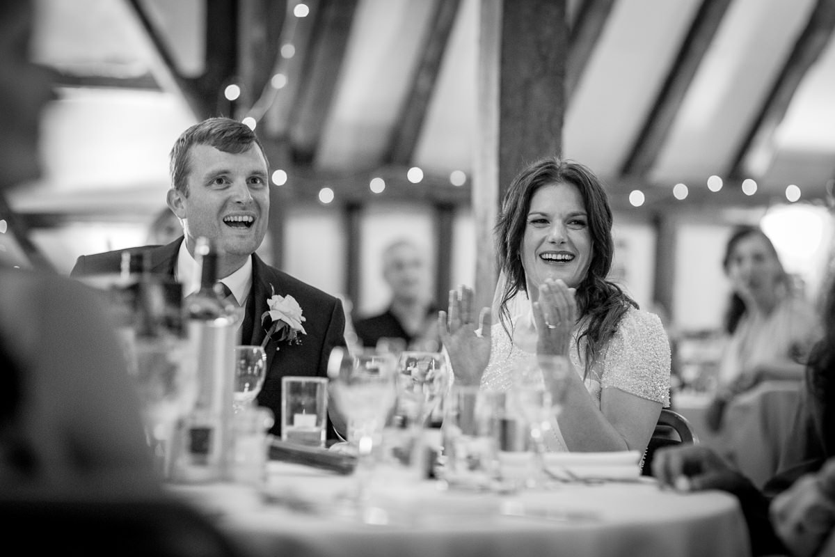black_and_white image wedding breakfast speeches bride groom outdoor wedding portrait at barn wedding venue kent the_plough_at_leigh by documentary wedding photographer surrey sussex for natural colourful and authentic LGBTQ_friendly wedding photography