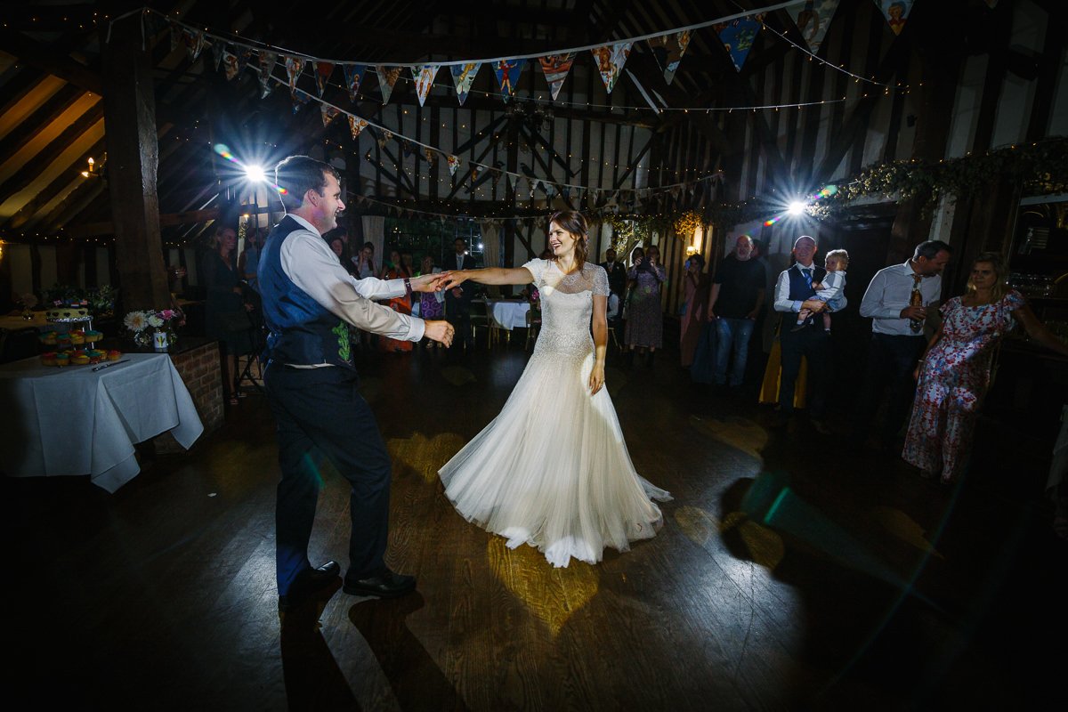 bride groom first dance at barn wedding venue kent the_plough_at_leigh by documentary wedding photographer surrey sussex for natural colourful and authentic LGBTQ_friendly wedding photography