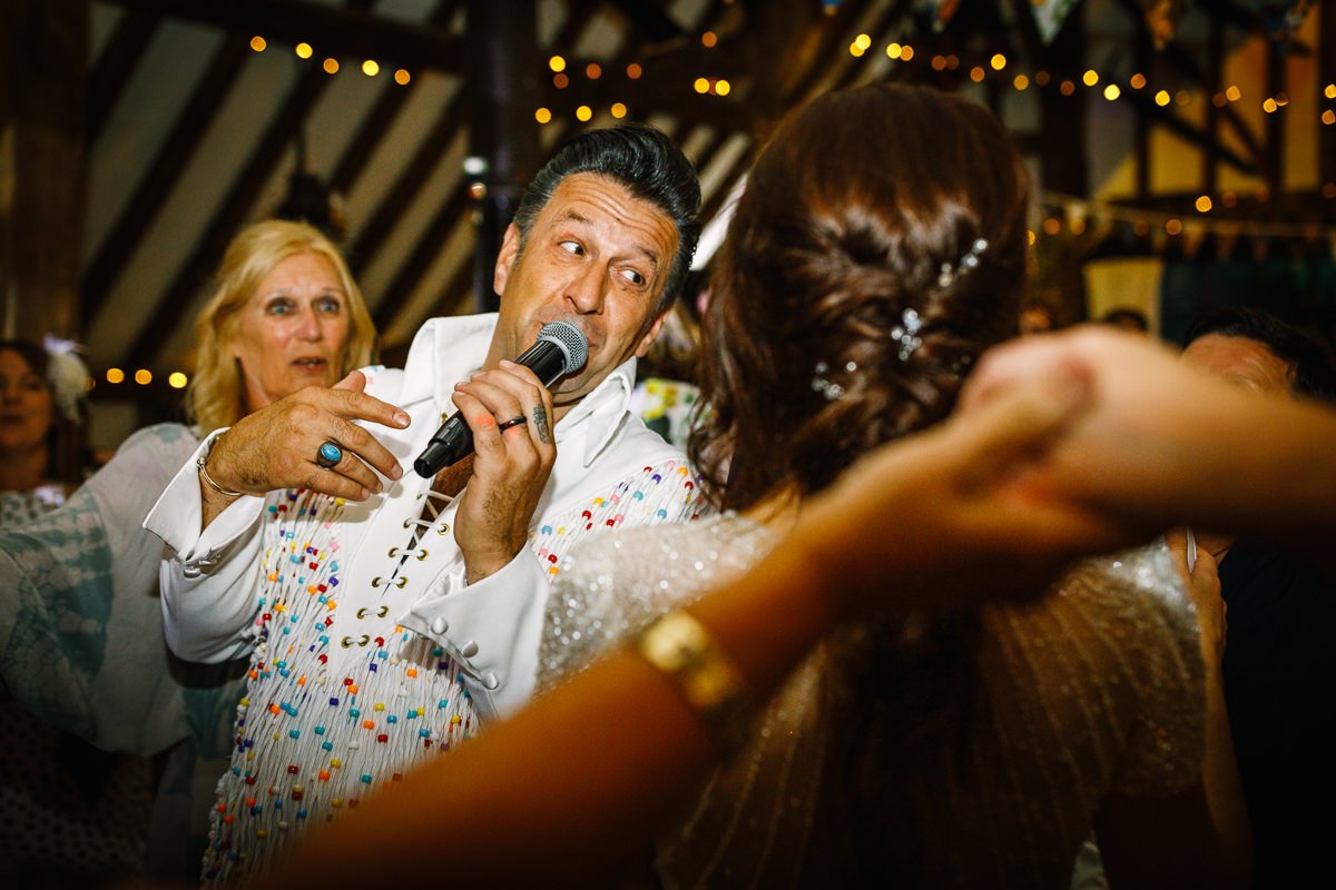 elivis bride groom first dance at barn wedding venue kent the_plough_at_leigh by documentary wedding photographer surrey sussex for natural colourful and authentic LGBTQ_friendly wedding photography