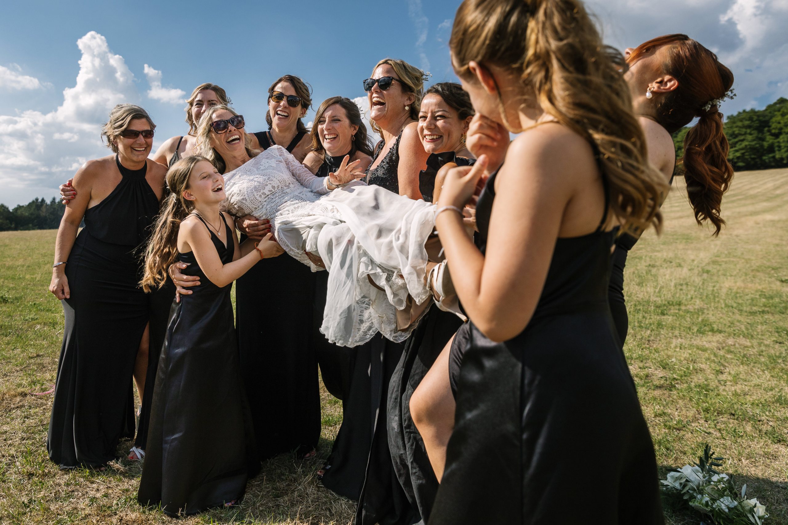 bride and bridesmaids having fun during the outdoor wedding reception natural unposed candid wedding photography by LGBTQ_friendly documentary wedding photographer surrey sussex
