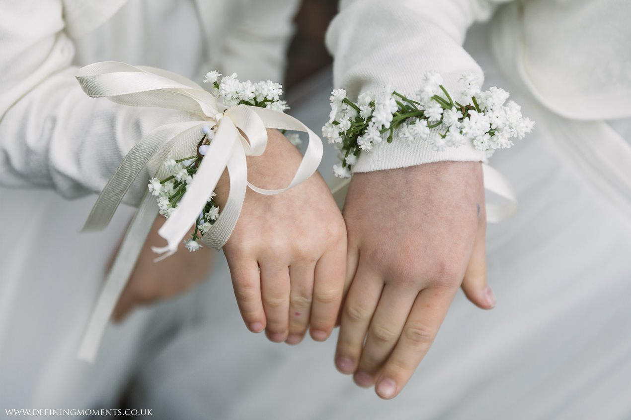 flower girls wrist corsage for wedding at gildings_barns-documentary-wedding-photographer-surrey-sussex