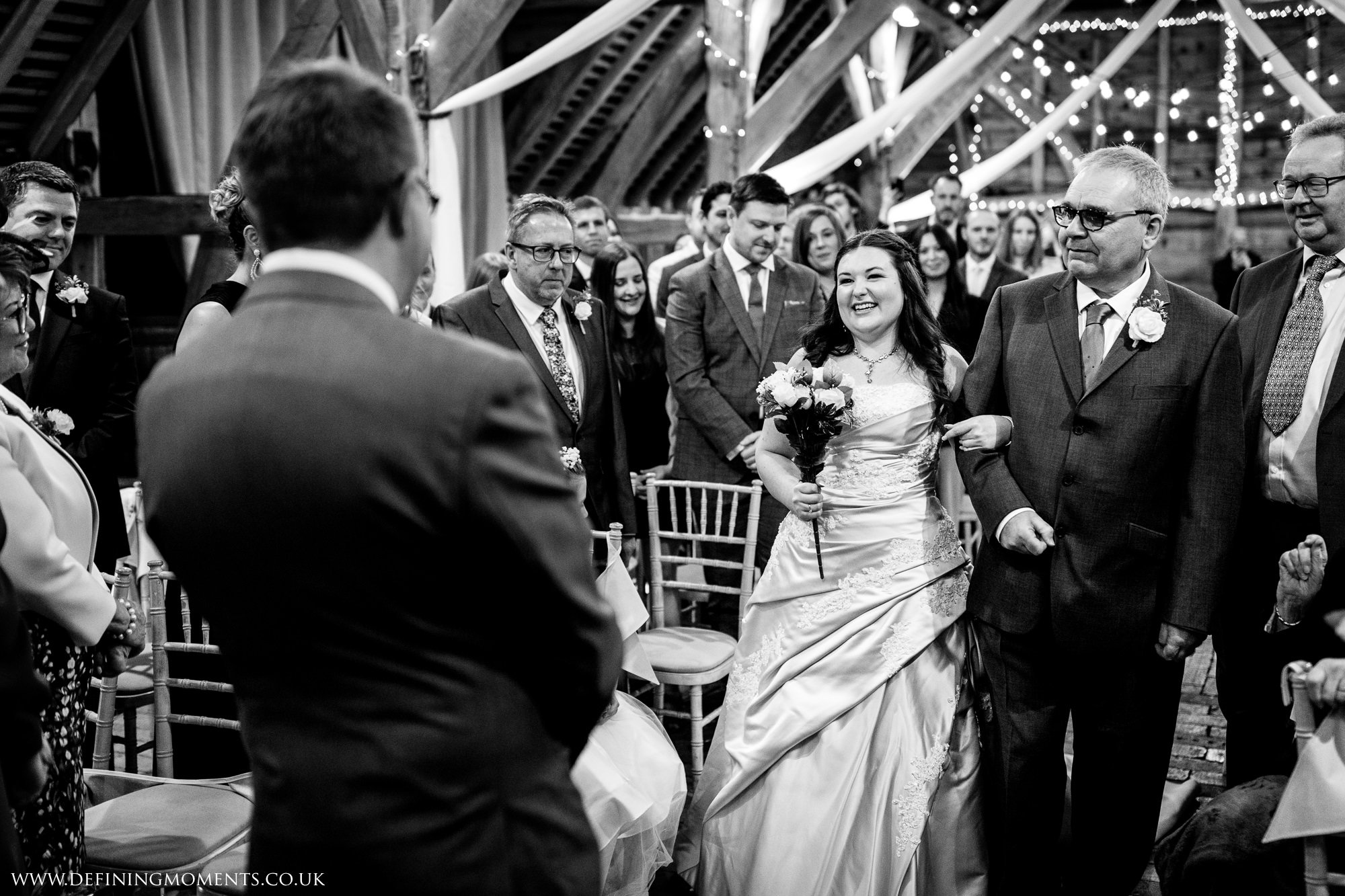 bride walking down the aisle with father of the bride at gildings_barns-documentary-wedding-photographer-surrey-sussex