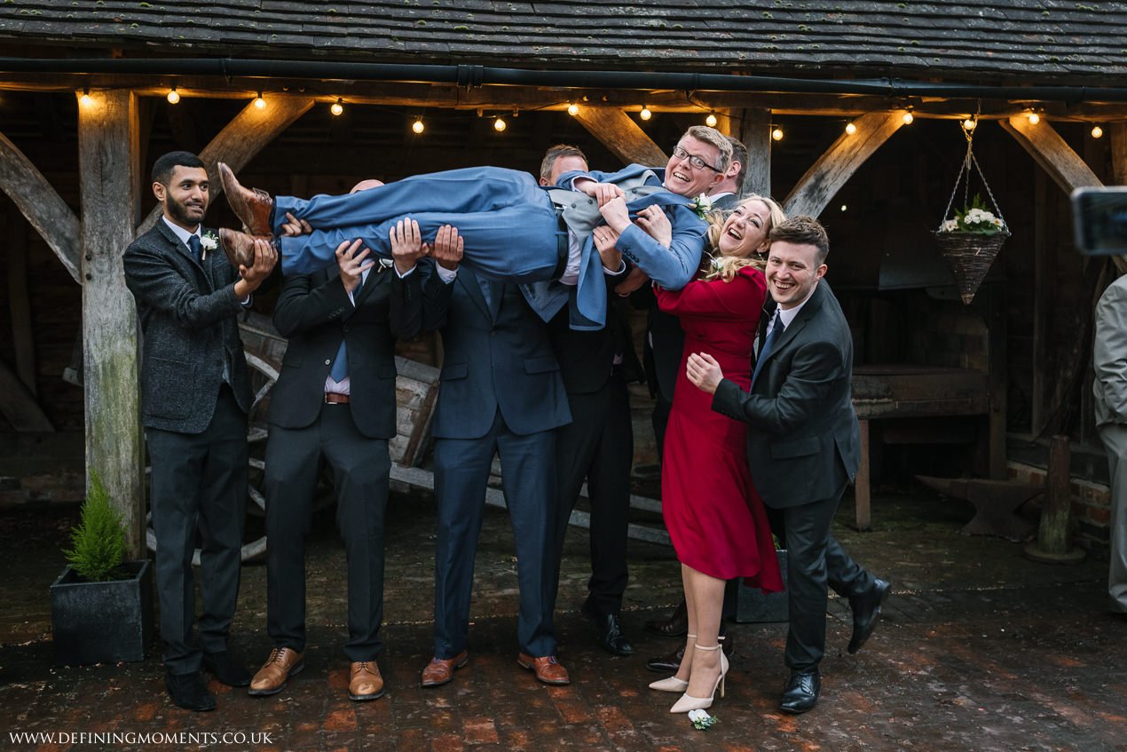 group portrait with planking groom at gildings_barns-documentary-wedding-photographer-surrey-sussex