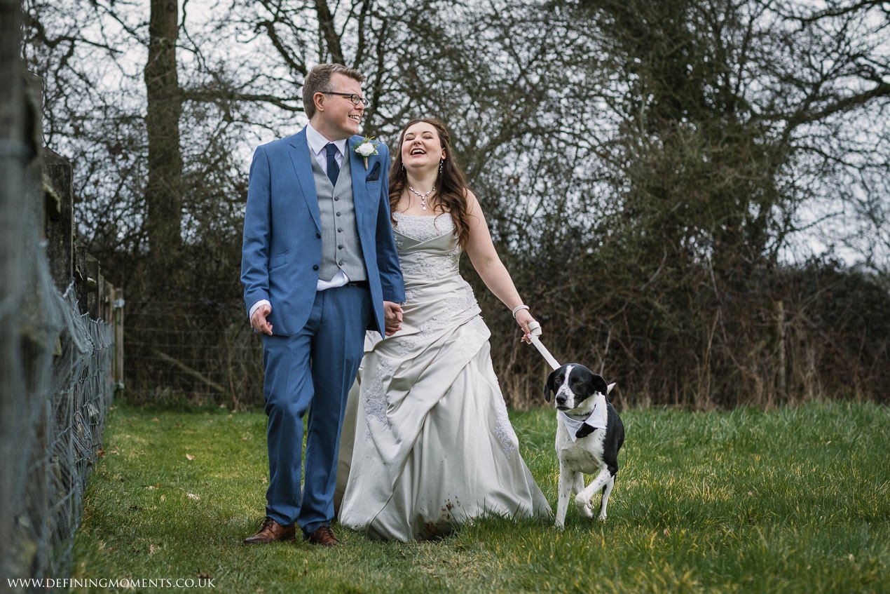 bride groom couple and their dog for wedding portrait outdoor at gildings_barns-documentary-wedding-photographer-surrey-sussex