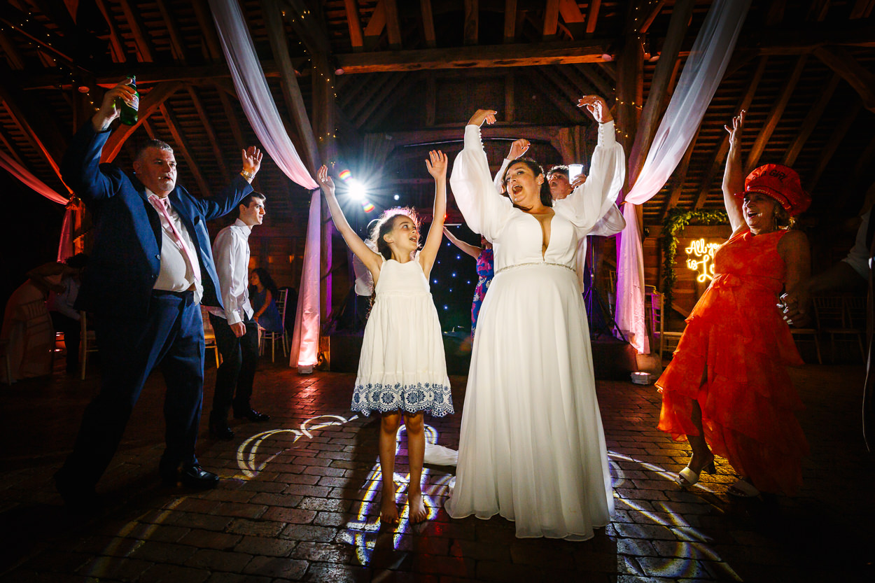 bride having fun on the dance floor in barn at relaxed gildings_barns wedding photography by documentary wedding photographer surrey sussex