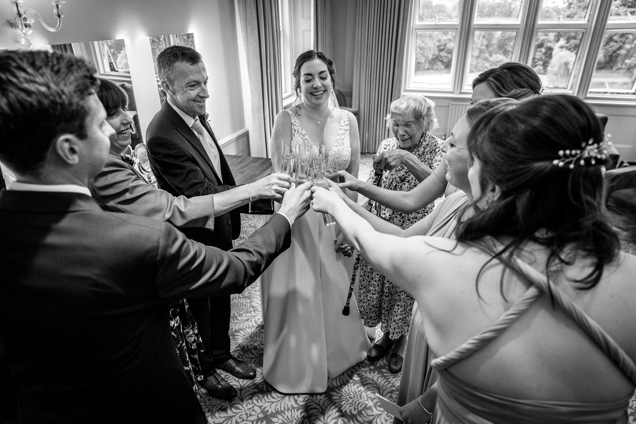 champagne toast black_white image at Hartsfield_Manor_wedding Surrey by documentary wedding photographer surrey for candid natural unposed authentic LGBTQ_friendly documentary photography