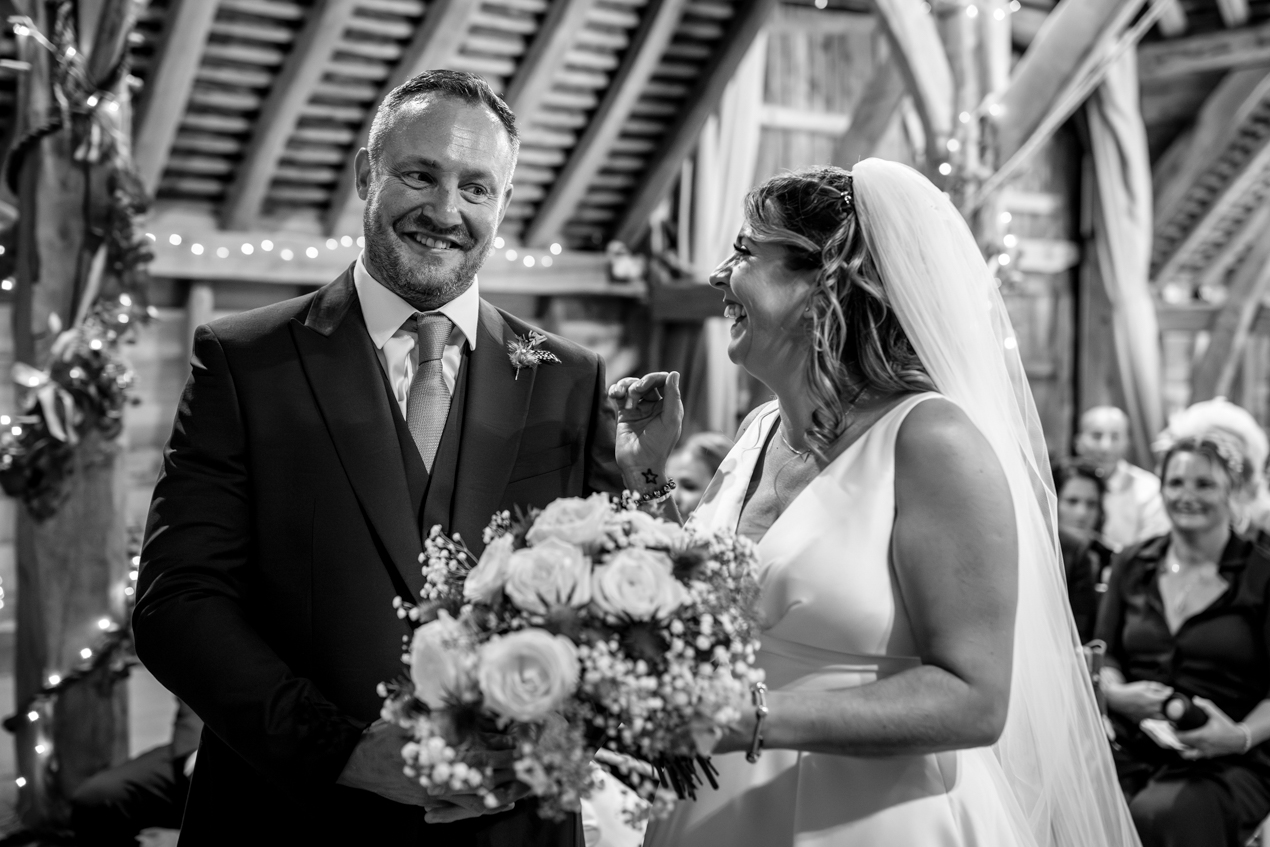 black_white image groom seeing bride at ceremony candid gildings_barns wedding photography by documentary wedding photographer surrey sussex
