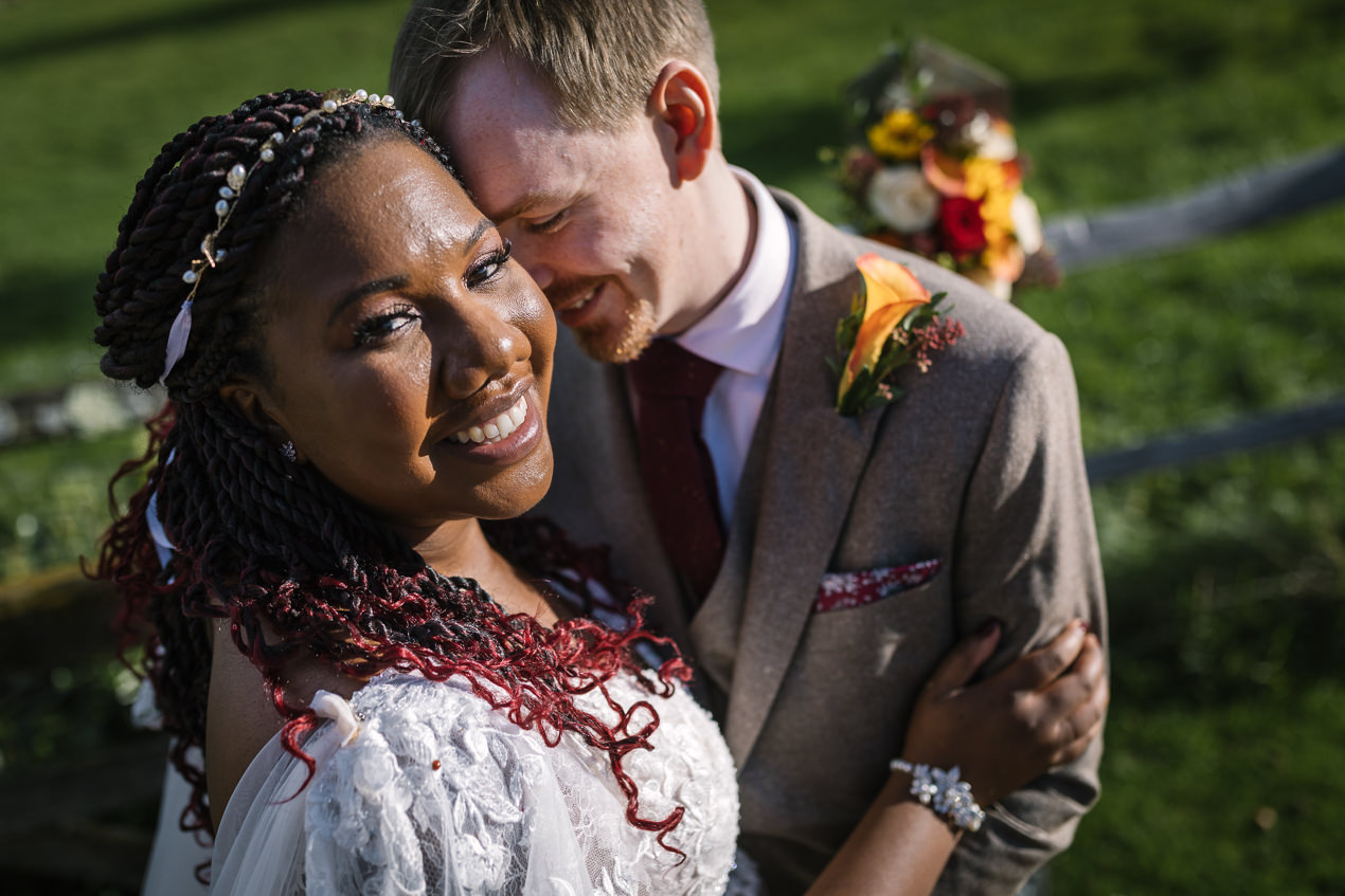 loving moment during couple portraits of bride and groom outside at relaxed gate_street_barn wedding guildford with candid unposed natural storytelling wedding photography by documentary wedding photographer surrey sussex