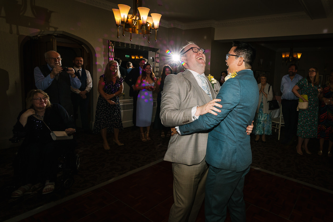 grooms first dance at same_sex gay wedding nutfield_priory natural candid unposed natural storytelling wedding photography by documentary lgbtq_friendly wedding photographer surrey sussex